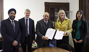Image of NLU and University of Glasgow staff signing an MoU