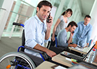 Image of an office based worker using a wheelchair