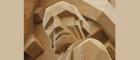 photograph of a cubist sculpture in sandstone of the head of a man with very sharp features