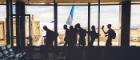 Travellers silhouetted against a window in an airport