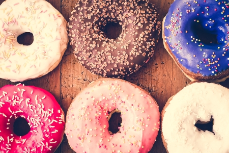 Photo of different coloured doughnuts