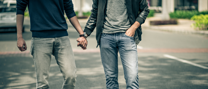 Two men walking hand in hand