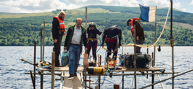 Divers exiting the water and Prof Cook taking the samples to the shore