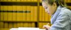 Image of a woman studying in a library.