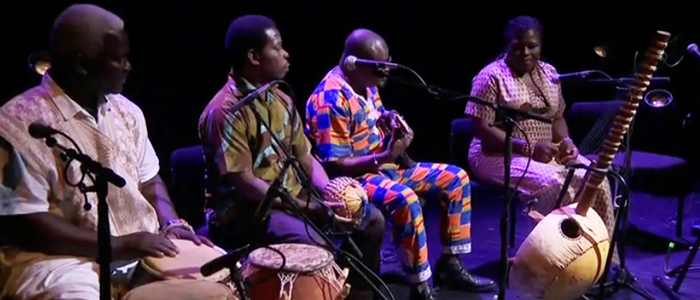 Image of UNESCO Chair programme in Refugee Integration through Languages and the Arts Artist in Residence, Naa Densua Tordzro  performing her composition on our refugee experiences with Karine Polwart at the Edinburgh International Festival. She is accompanied by PhD student and artist in residence Gameli Tordzro.