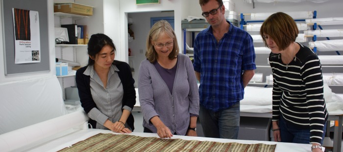 Image of the team working on a piece of Barkcloth