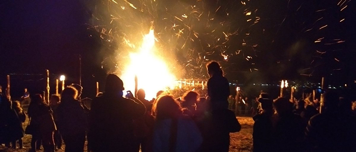 Image of Burning the Circle participants around a large fire