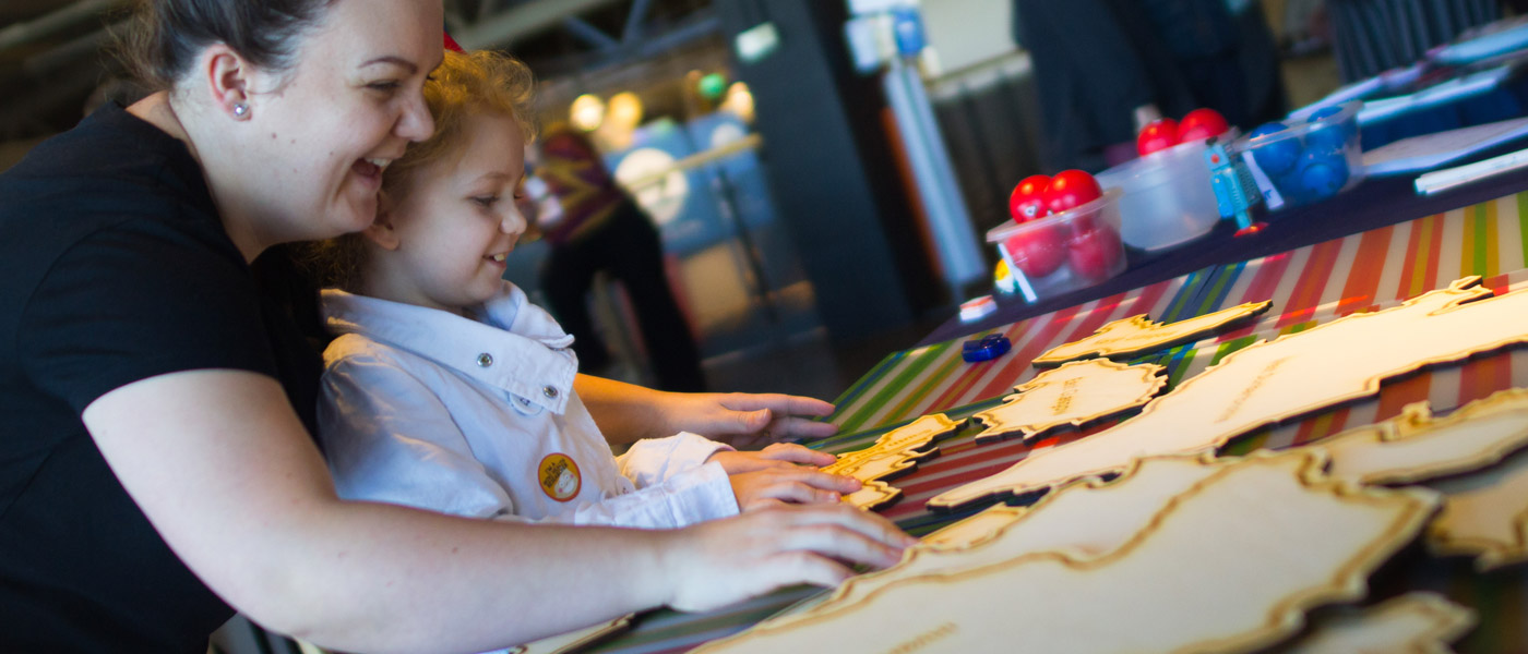 A member of staff and a young participant at the IKEA event