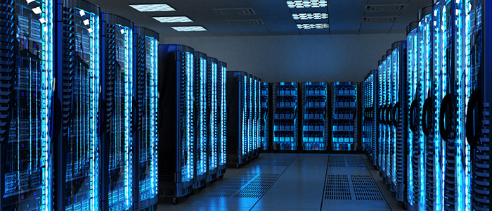 Image of many data servers in a brightly lit server room