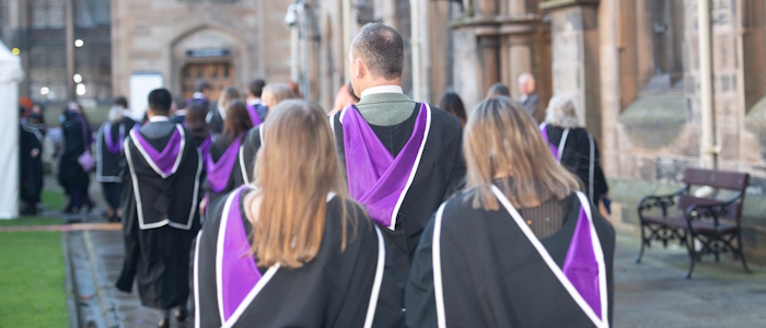 Students during graduation walking in the quadrangle