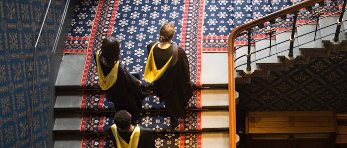 Students walking up stairs to Bute Hall during graduation