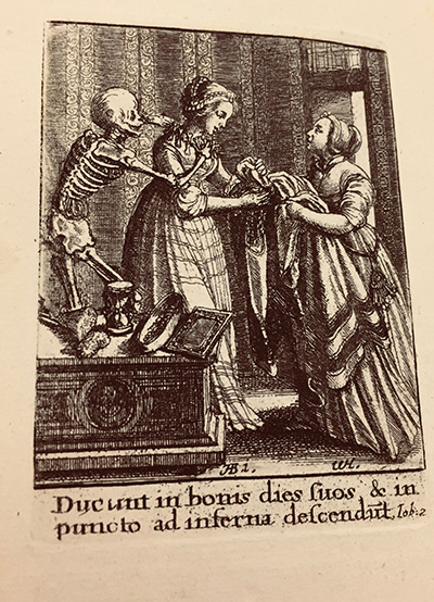 a monochrome print showing two moderately well dressed women and a skeleton. The skeleton is turned towards the woman on the left, reaching its arms around her shoulders as it placing a necklace around her.  The woman on the right is handing a dress to the first woman.