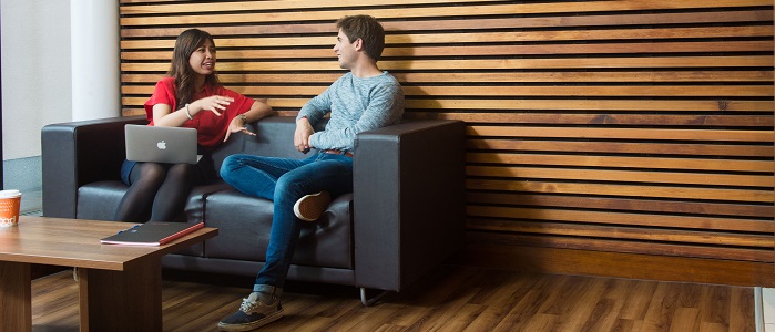 A man and women having a conversation in a couch