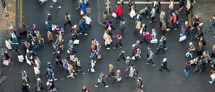 A view of British pedestrains at a road crossing, from above. 700 pixels