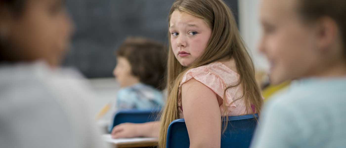 Girl looking over her shoulder in a classroom setting