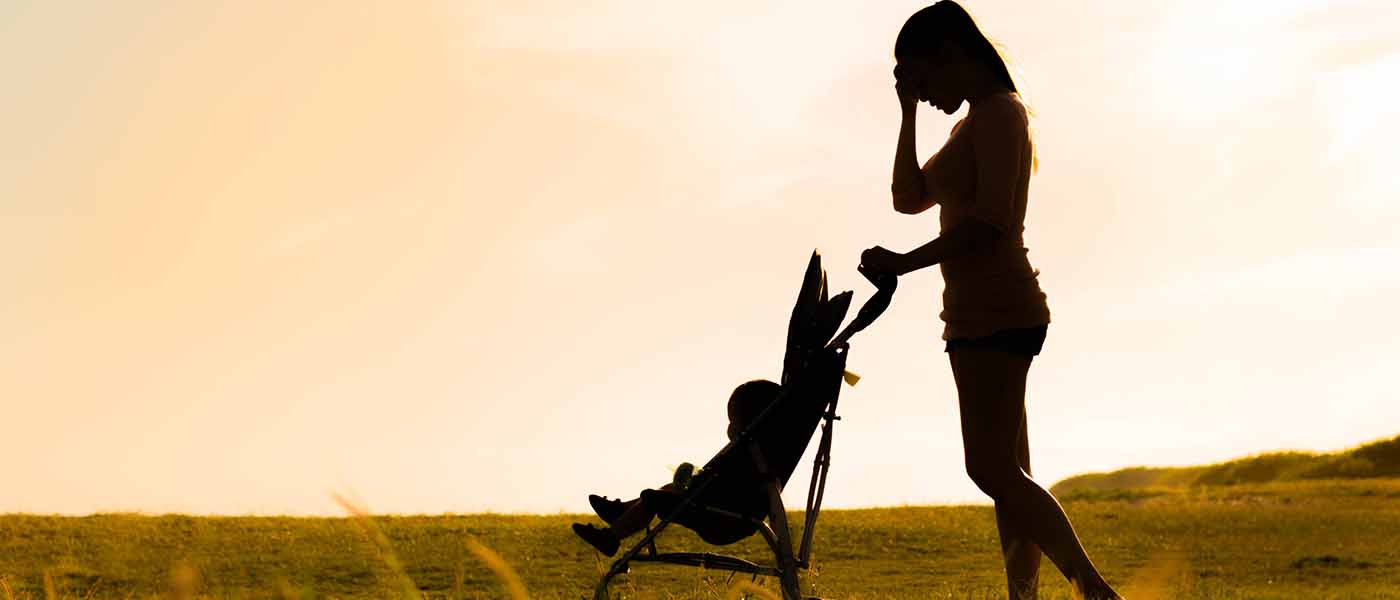 silhouette of mother pushing gochair