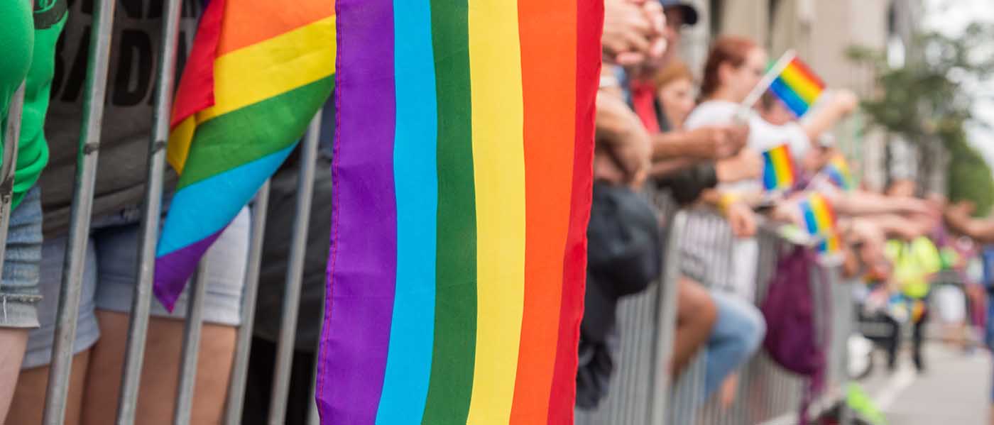 Pride flag hanging over a barrier