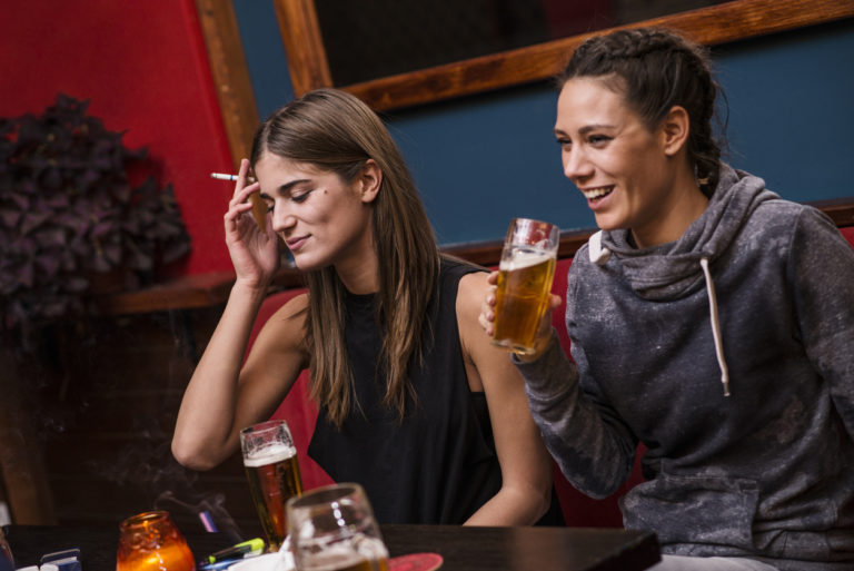 Young females smoking and drinking in a social setting, 768x513px