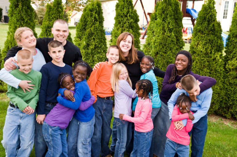 Photograph of a group of children and their carers, 768x510px