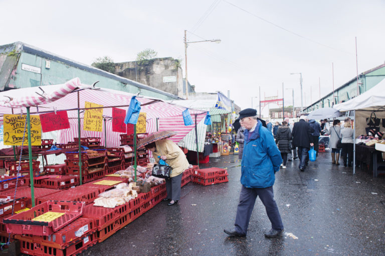 Glasgow, people walking around the historic Barras Market Place flea market. 768x512px