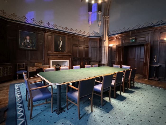 Flat floored meeting room with boardroom table and chairs and video monitor