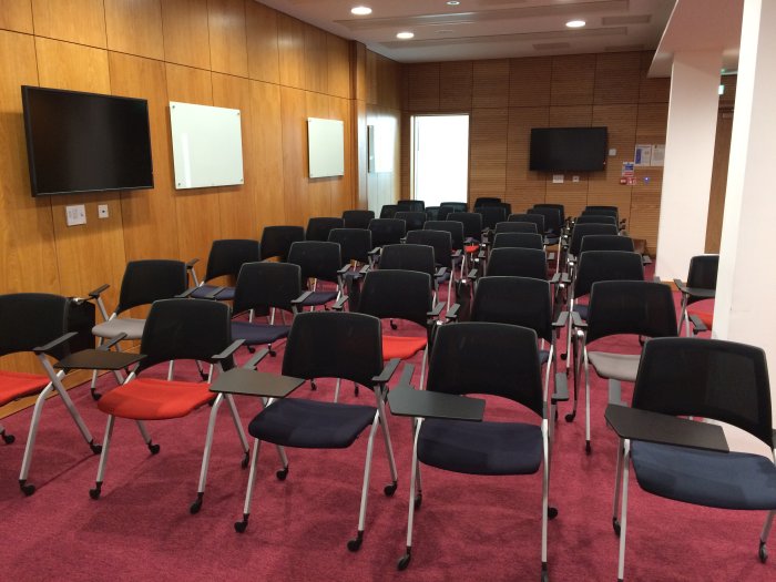 Flat floored teaching room with rows of tablet chairs