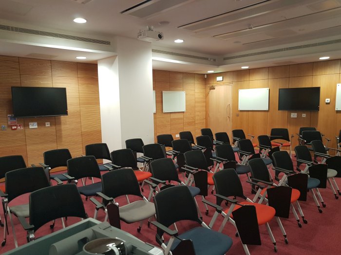 Flat floored teaching room with rows of tablet chairs