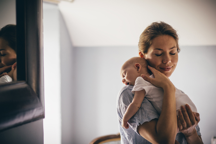 Mother holding young baby, 700px