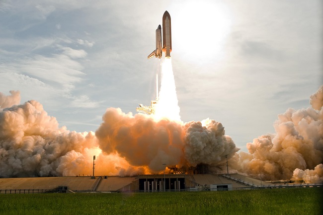 mage above: The fiery blaze below space shuttle Endeavour as it launches from NASA Kennedy Space Centre's Launch Pad 39A bathes the smoke and steam with an orange glow. Photo credit: NASA/Tony Gray