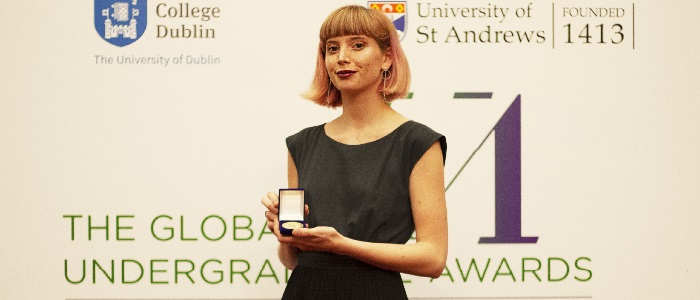 Undergraduate Awards Izzy Howlett with medal at ceremony in Dublin 700 x 300