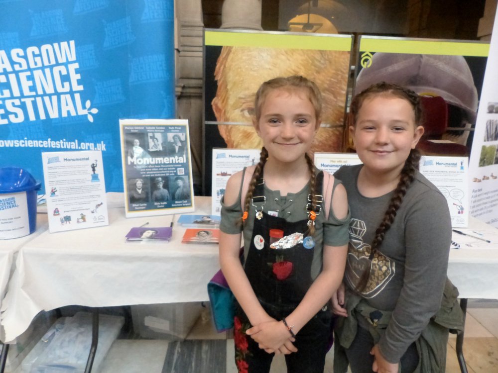 Girl showing off her badge after completing Monumental hunt game