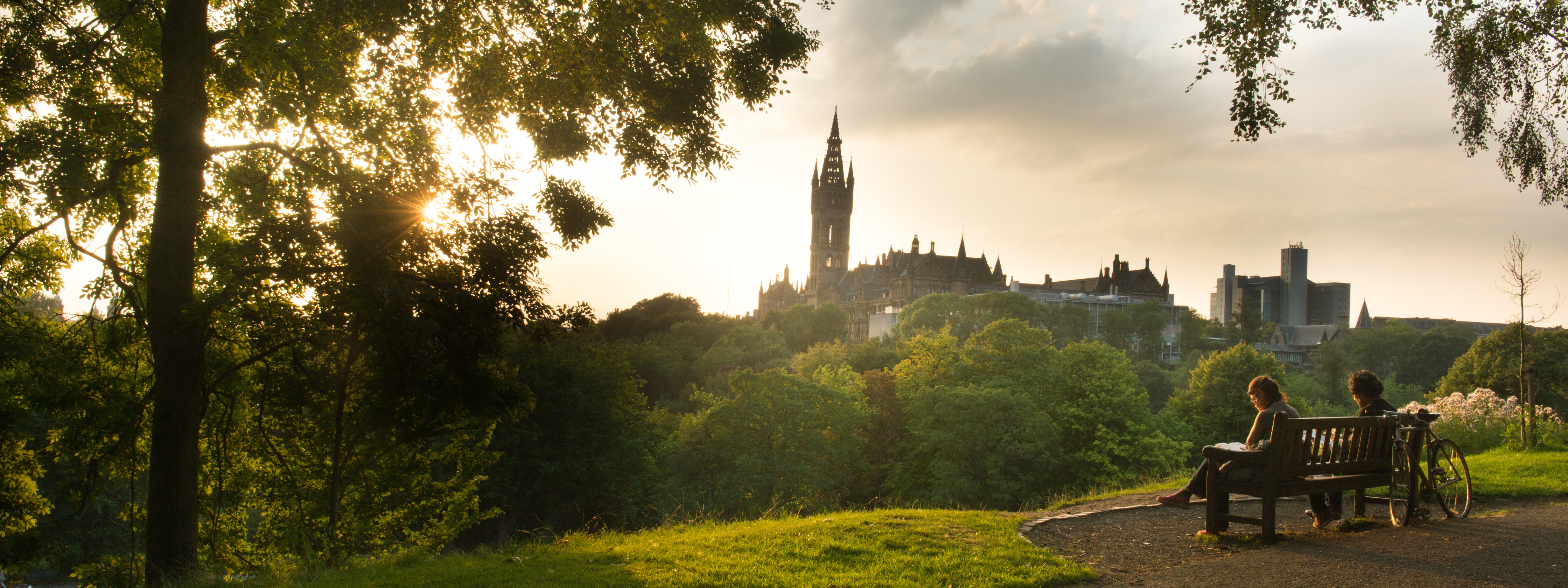 Glasgow University sunset with students on bench
