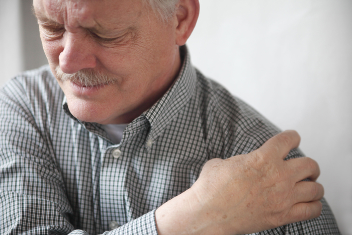 Photo of man experienceing shoulder pain