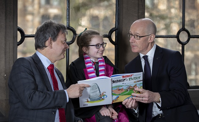 Professor Sir Anton Muscatelli, Paige Brown from St Patricks Primary School and Deputy First Minsiter John Swinnney help launch new teaching resources for schools created from UofG research.