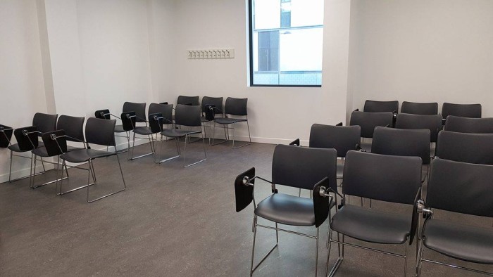 Flat floored teaching room with rows of tablet chairs