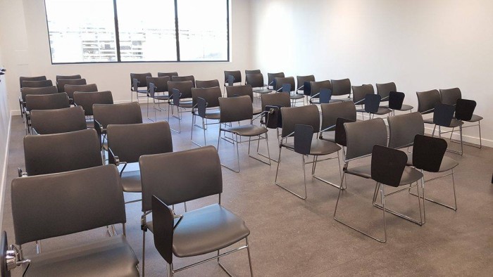 Flat floored teaching room with rows of tablet chairs