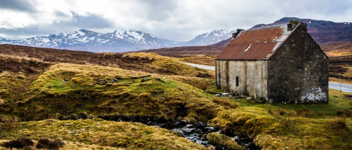 remote bothy by a mountain road