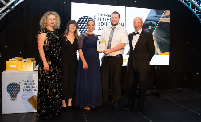 Staff collecting the Herald award
