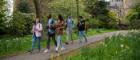A group of students walking through Kelvingrove park next to the University campus.