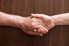 Older people holding hands