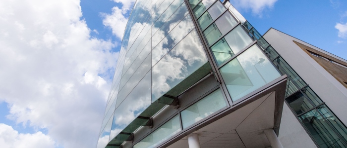 A low angle looking up at the outside of the Wolfson Medical School