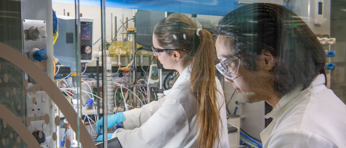 two digital chemistry students in a lab with lots of equipment