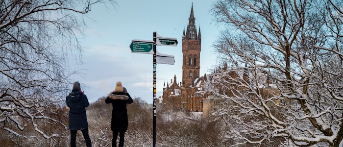 Students looking at the tower next to a sign post