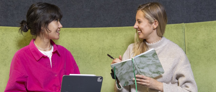 Two language students chatting while studying
