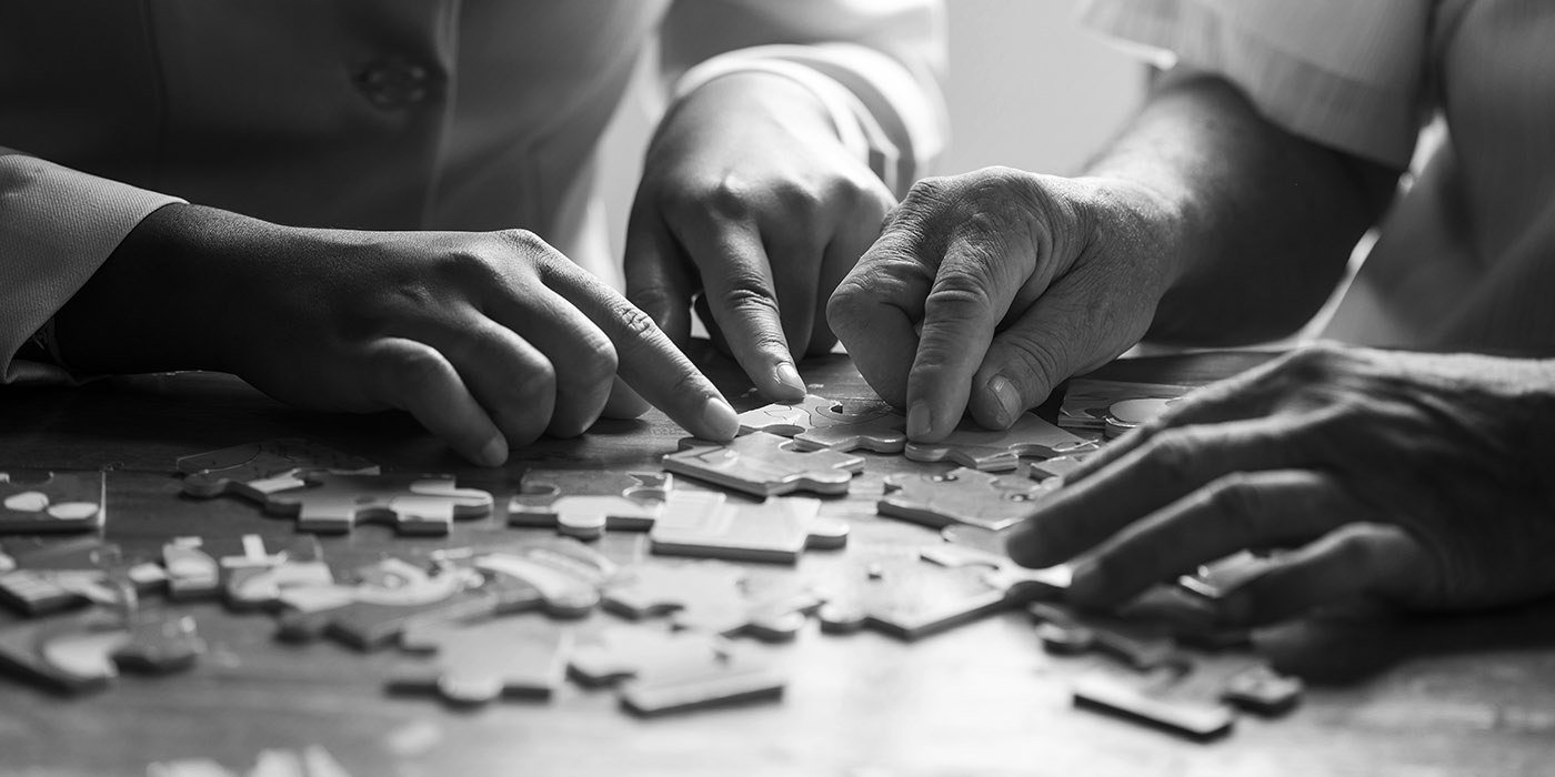 Two people building a jigsaw puzzle