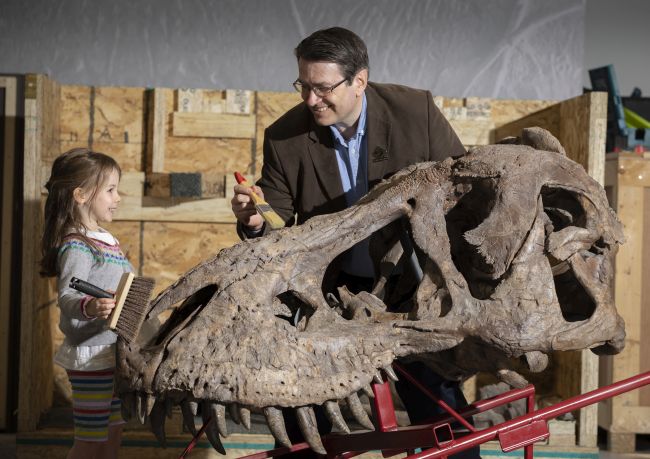 Trix the T.rex arrival - Dr Neil Clark and Martha Scott, aged 4 with Trix the T.rex  Photo Credit Martin Shields