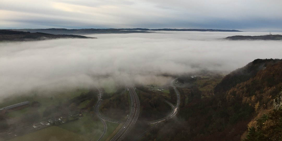 A photo of roads through a thick cloud of fog