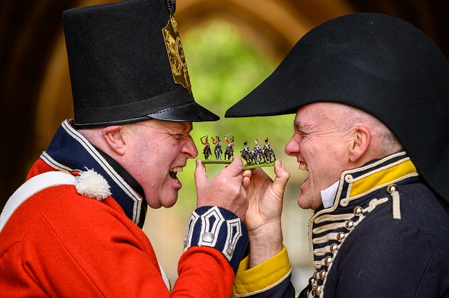 Left to right Napoleonic re-enactor Rob Woods of the First Regiment of Foot, Royal Scots (Red uniform) with University of Glasgow PhD student Jon Cooper (Navy uniform) with some of the 20,000 28mm miniature soldiers being used to replay the Battle of Waterloo at the University of Glasgow this weekend. It will be the biggest ever historical table top war game. Credit: John Young / YoungMedia.co.uk 