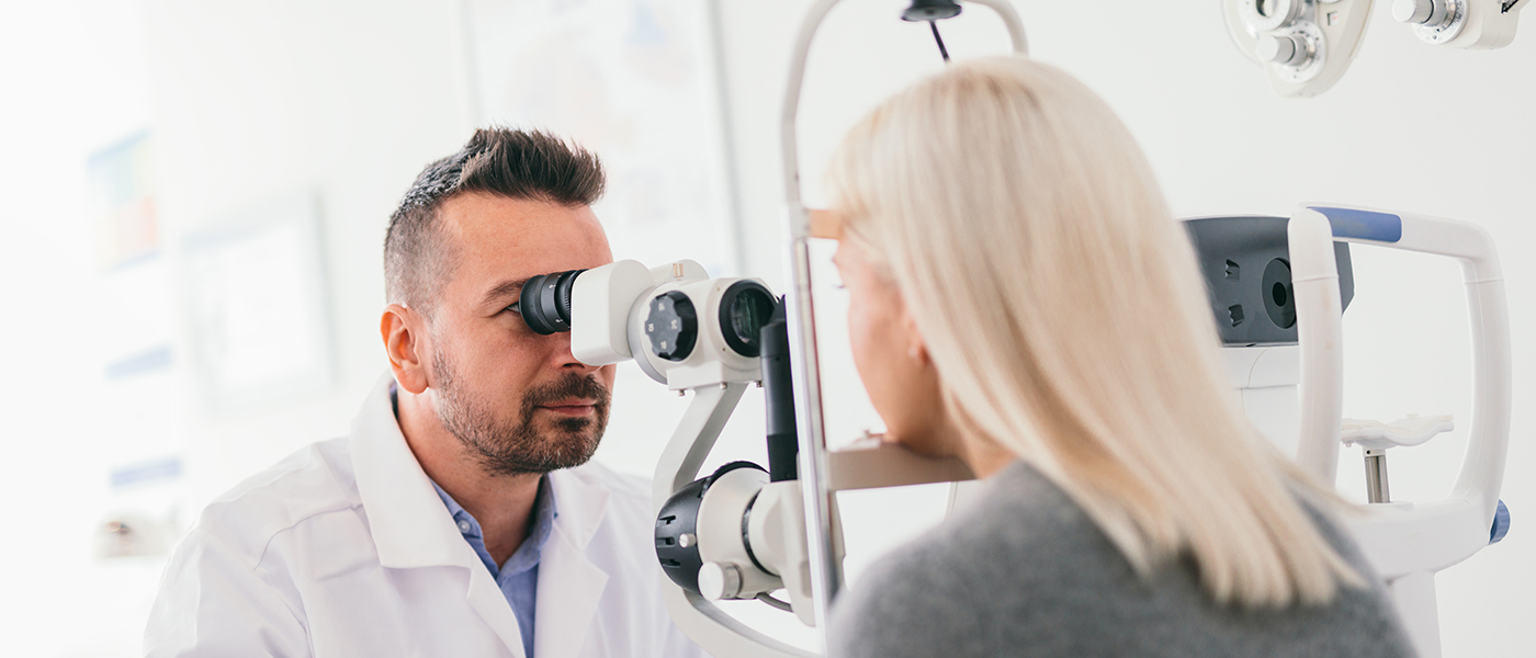 Patient being given an eye test by an optician 
