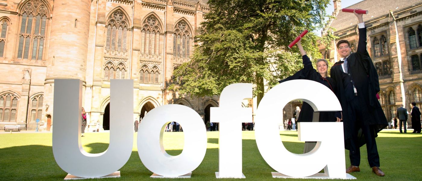 Graduating students with large UofG letters in the quadrant